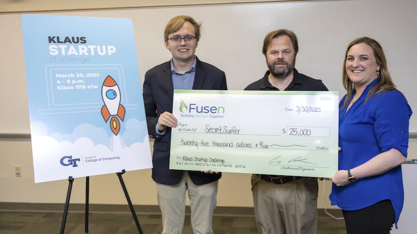 Student winner poses with $25K check from Klaus Startup Challenge at Georgia Tech