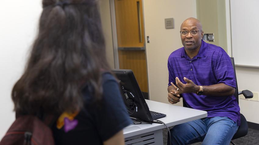 Georgia Tech's Cedric Stallworth speaking with a student