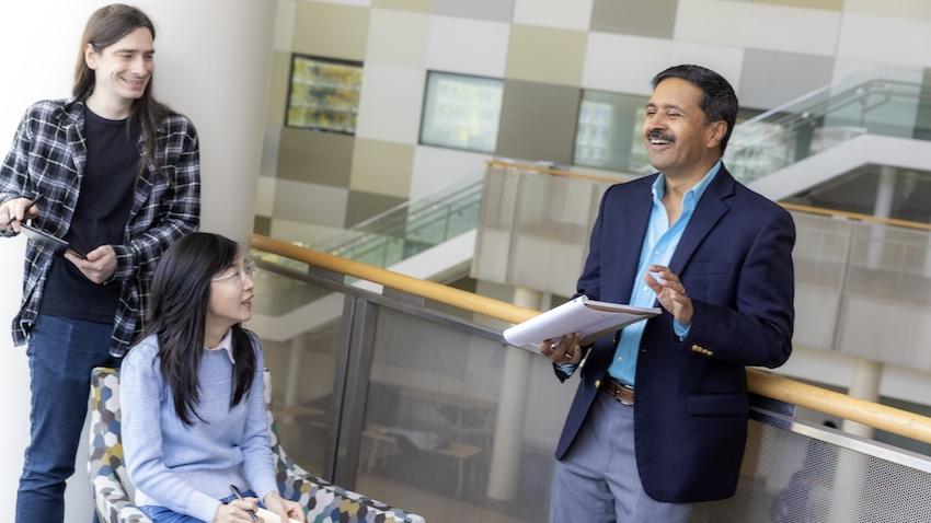 GT Dean of Computing Vivek Sarkar talks with faculty members