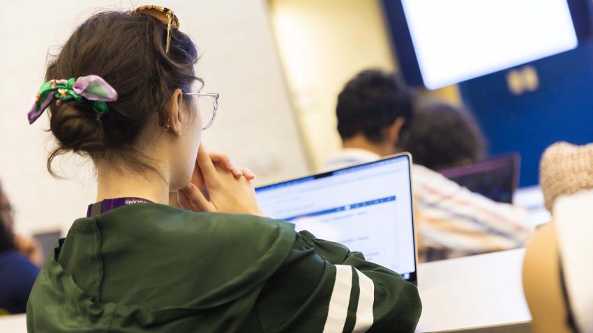 Student works on a laptop in class.