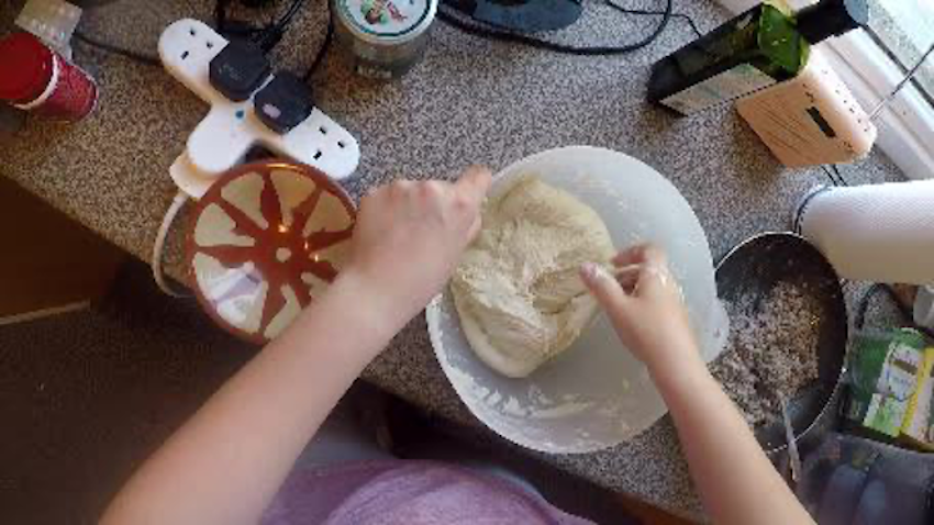 a person kneading dough