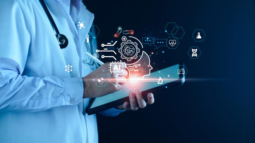 An image depicting a doctor in a white coat putting patient notes into a tablet. Hovering over his hands are digital images of a person's head, AI, pills, heart beat, and other medical related devices. The image uses a mix of a real photo and computer generated images to support the article's description of how AI might be used in high stakes situations.