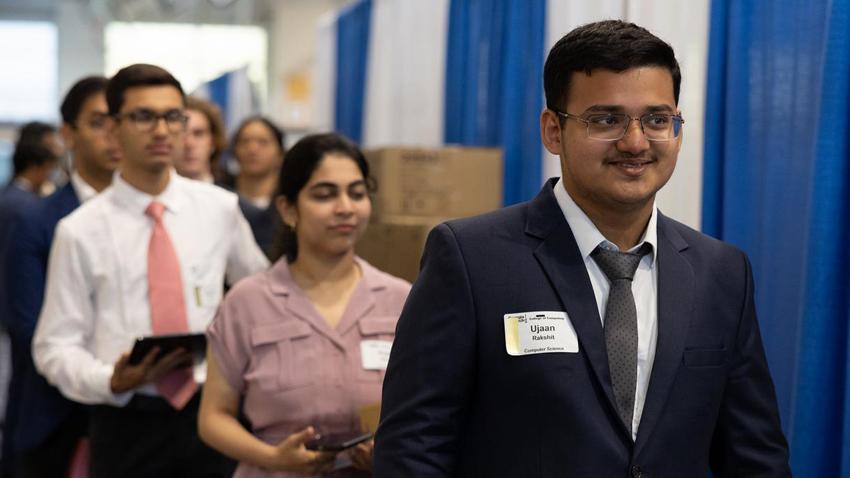Students standing in line for job interviews.