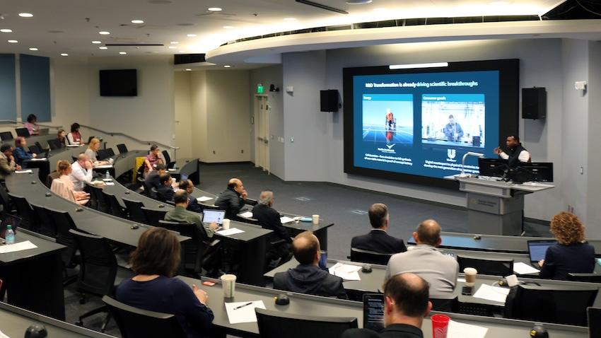 Man presenting in lecture room.