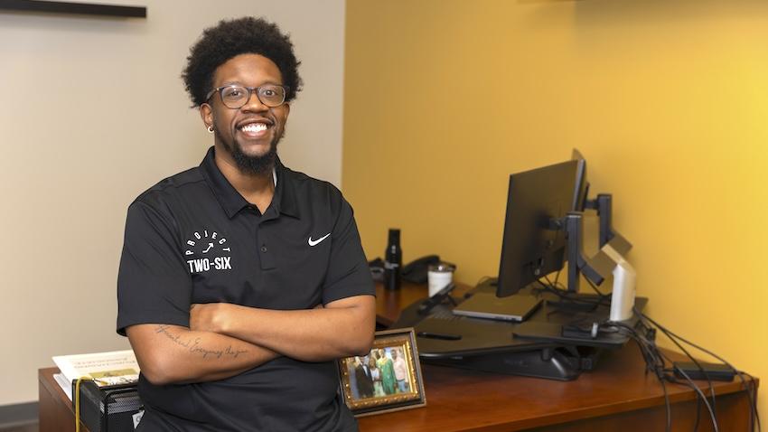 GT Computing procurement coordinator Michael Goodson poses with a smile in his office at Georgia Tech