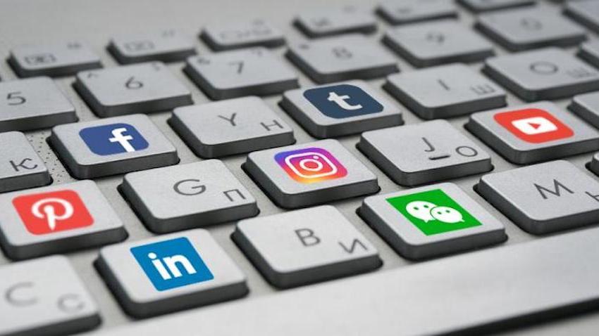Social media logos appear on keys of a computer keyboard