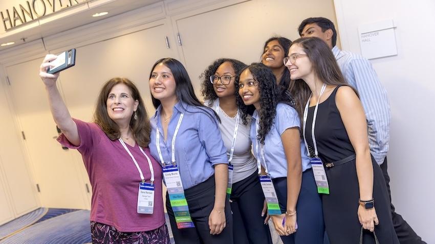 Regents Professor Dana Randall takes a selfie with a small group of students attending Tapia 2026 in Atlanta.