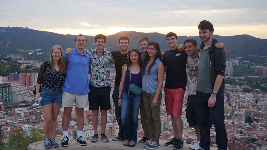 Students standing with mountain and city behind them