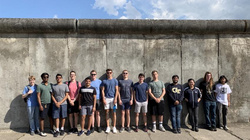 Students standing along the Berlin Wall