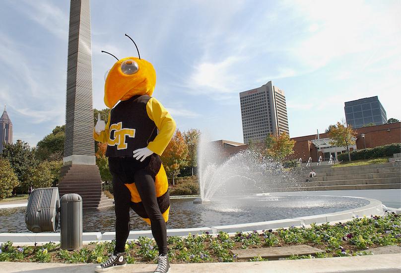 Buzz mascot stands in front of central tech water tower