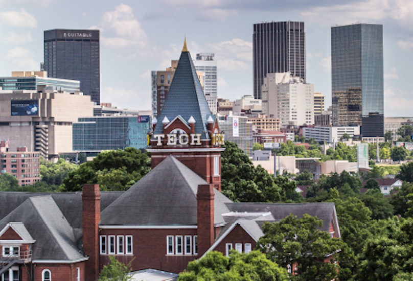 Georgia Tech's Tech Tower is scene in the foreground in front of high rises along the Atlanta skyline.