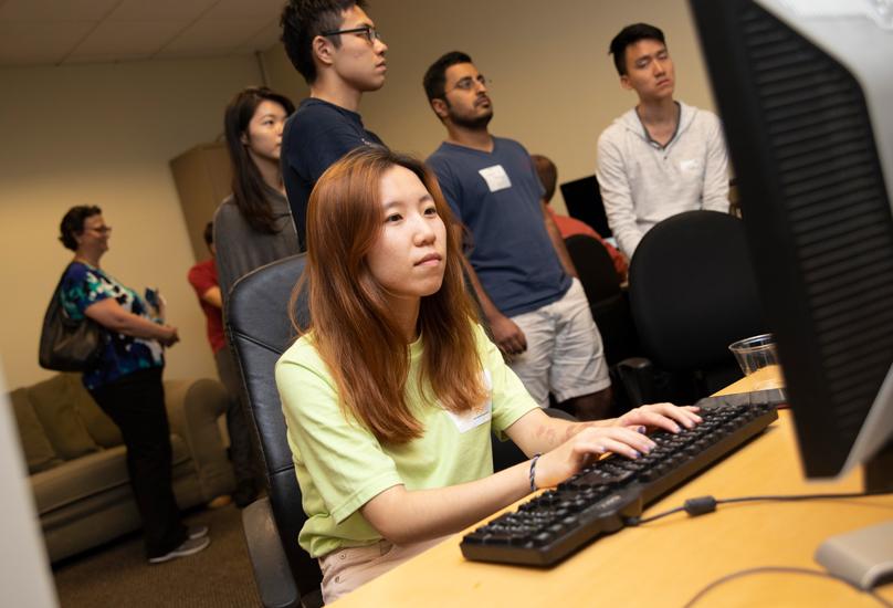 Graduate student typing on computer