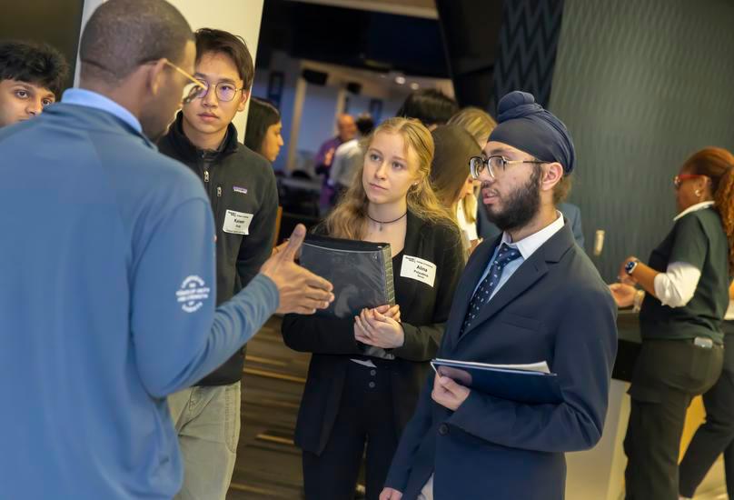 Students meeting with a corporate recruiter.