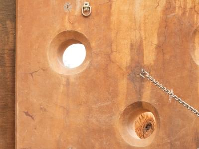 Elephant at Zoo Atlanta sticks its trunk into a hole in the enrichment wall