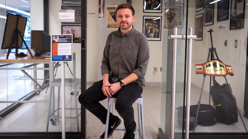 Seated potrait of GT Computing creative producer Kevin Beasley fronting his indie wrestling photo exhibit