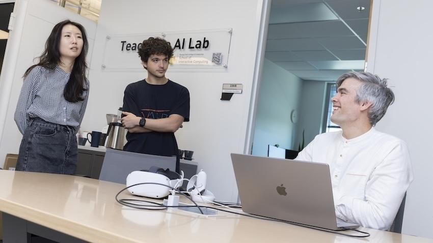 Assistant Professor Chris MacClellan talks with two of his students