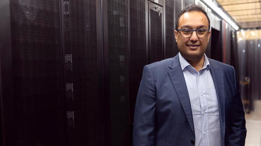 Man standing in data center room.